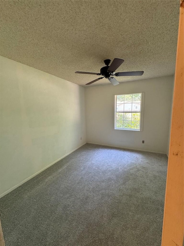 405 Lynch St, Smithville, TX 78957 - empty room featuring carpet flooring, a ceiling fan, and a textured ceiling