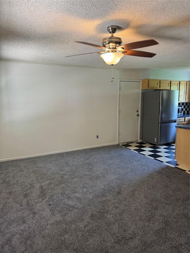 405 Lynch St, Smithville, TX 78957 - unfurnished living room with ceiling fan, a textured ceiling, and carpet floors