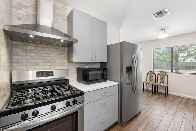 2006 Heathwood Cir, Round Rock, TX 78664 - kitchen with appliances with stainless steel finishes, wall chimney exhaust hood, decorative backsplash, light countertops, and baseboards
