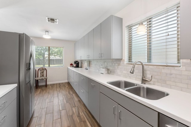 2006 Heathwood Cir, Round Rock, TX 78664 - kitchen with gray cabinets, stainless steel appliances, and a sink