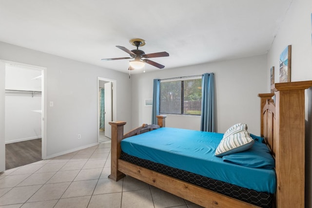 2006 Heathwood Cir, Round Rock, TX 78664 - bedroom featuring a ceiling fan, a spacious closet, baseboards, light tile patterned floors, and ensuite bathroom