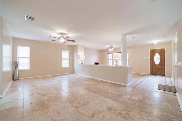 11228 Pickard Ln, Austin, TX 78748 - unfurnished living room featuring ornate columns, a ceiling fan, and baseboards
