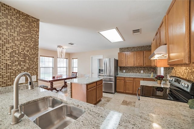 11228 Pickard Ln, Austin, TX 78748 - kitchen featuring appliances with stainless steel finishes, under cabinet range hood, a sink, and decorative backsplash