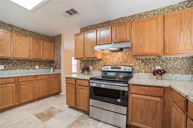 11228 Pickard Ln, Austin, TX 78748 - kitchen featuring stainless steel range with electric cooktop, under cabinet range hood, decorative backsplash, light stone counters, and brown cabinetry