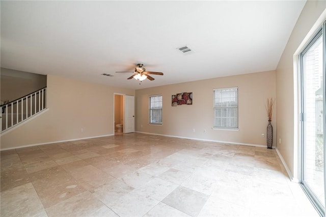 11228 Pickard Ln, Austin, TX 78748 - empty room with ceiling fan, stairway, and baseboards