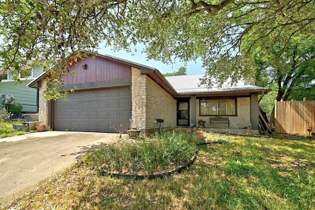507 W Dittmar Rd, Austin, TX 78745 - ranch-style home featuring an attached garage, concrete driveway, metal roof, and stone siding