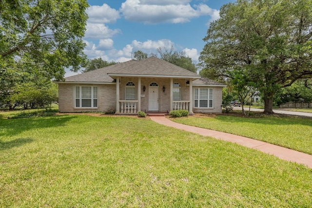 302 Rather St, Gonzales, TX 78629 - bungalow with a porch, a front yard, roof with shingles, and brick siding