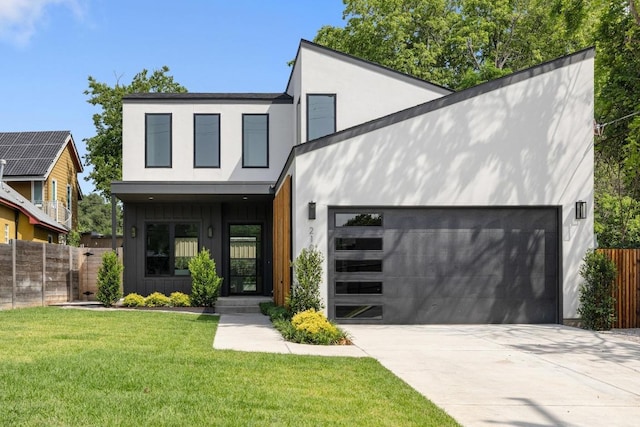 2106 Thornton Rd, Austin, TX 78704 - contemporary house with concrete driveway, an attached garage, and stucco siding