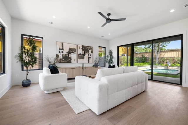 2106 Thornton Rd, Austin, TX 78704 - living area featuring light wood-style floors, a ceiling fan, recessed lighting, and baseboards