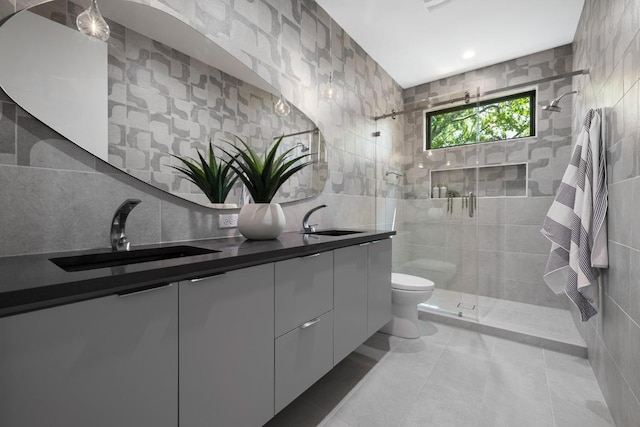 2106 Thornton Rd, Austin, TX 78704 - bathroom featuring tile walls, a stall shower, double vanity, toilet, and tile patterned floors