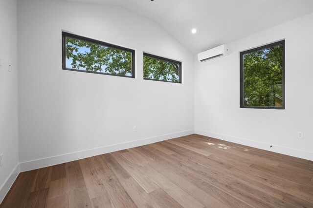 2106 Thornton Rd, Austin, TX 78704 - empty room with a wall mounted AC, healthy amount of natural light, lofted ceiling, baseboards, and recessed lighting