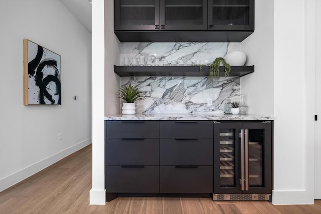 2106 Thornton Rd, Austin, TX 78704 - indoor dry bar featuring wine cooler, decorative backsplash, light wood-type flooring, and baseboards