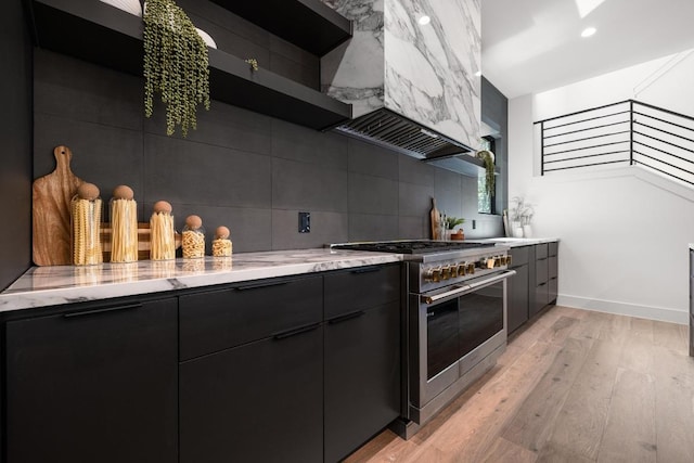 2106 Thornton Rd, Austin, TX 78704 - kitchen with stainless steel range, custom exhaust hood, modern cabinets, and decorative backsplash