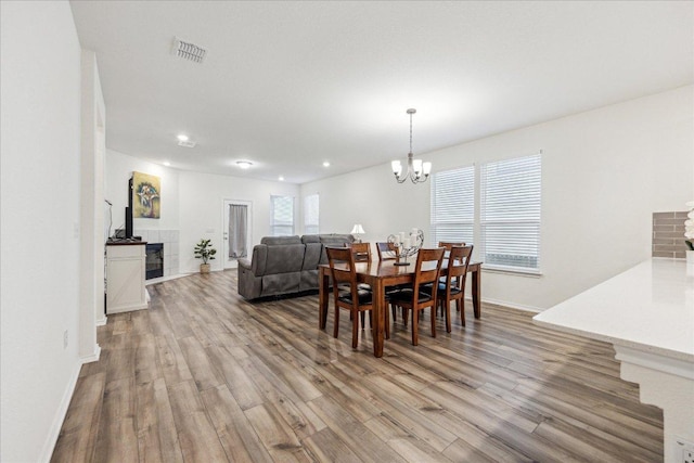 7008 Daniel Ranch Dr, Austin, TX 78744 - dining space with wood finished floors, baseboards, a chandelier, and recessed lighting