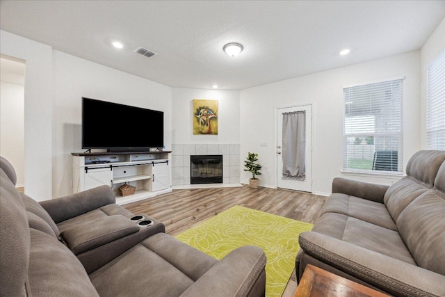 7008 Daniel Ranch Dr, Austin, TX 78744 - living area featuring wood finished floors, a fireplace, and recessed lighting