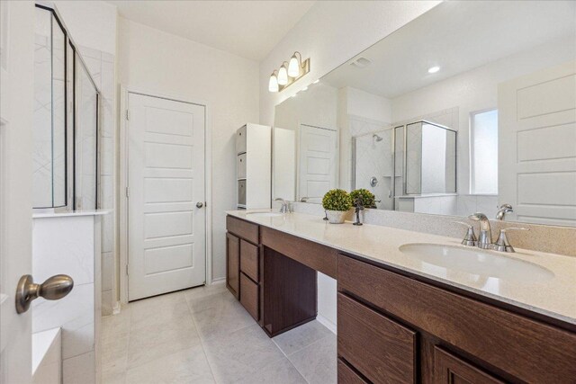 7008 Daniel Ranch Dr, Austin, TX 78744 - bathroom featuring a shower stall, double vanity, and tile patterned floors