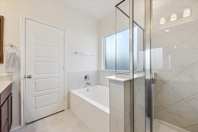 7008 Daniel Ranch Dr, Austin, TX 78744 - full bathroom featuring vanity, a bath, a stall shower, and tile patterned floors
