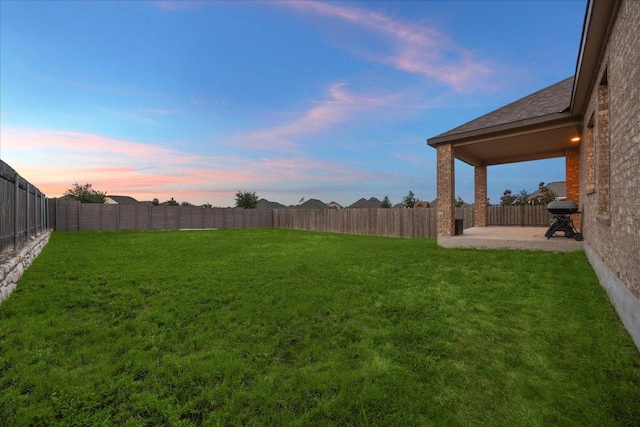 7008 Daniel Ranch Dr, Austin, TX 78744 - yard at dusk featuring a patio area