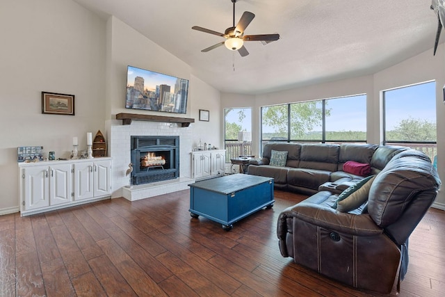 156 Lakefront Dr, Point Venture, TX 78645 - living area featuring a ceiling fan, dark wood-style flooring, a fireplace, and high vaulted ceiling
