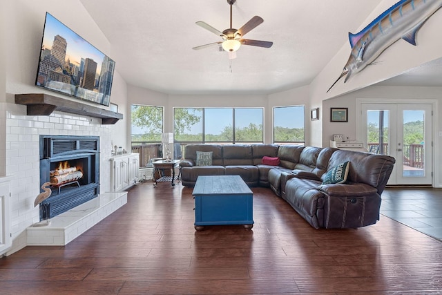 156 Lakefront Dr, Point Venture, TX 78645 - living area featuring ceiling fan, a brick fireplace, dark wood finished floors, and french doors