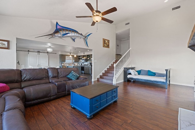 156 Lakefront Dr, Point Venture, TX 78645 - living room featuring a ceiling fan, dark wood-style flooring, baseboards, stairs, and a towering ceiling