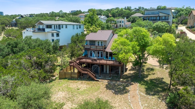 156 Lakefront Dr, Point Venture, TX 78645 - back of house featuring stairs, a wooden deck, a residential view, metal roof, and a balcony