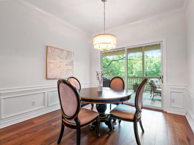 1300 Puddleby Cv, Austin, TX 78746 - dining room featuring wood finished floors, ornamental molding, a wainscoted wall, and a decorative wall