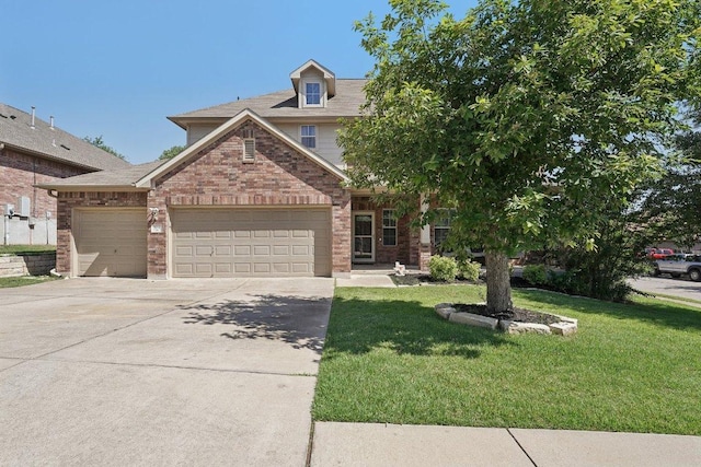 504 Chaparral Dr, Leander, TX 78641 - view of front of home featuring an attached garage, brick siding, driveway, and a front yard