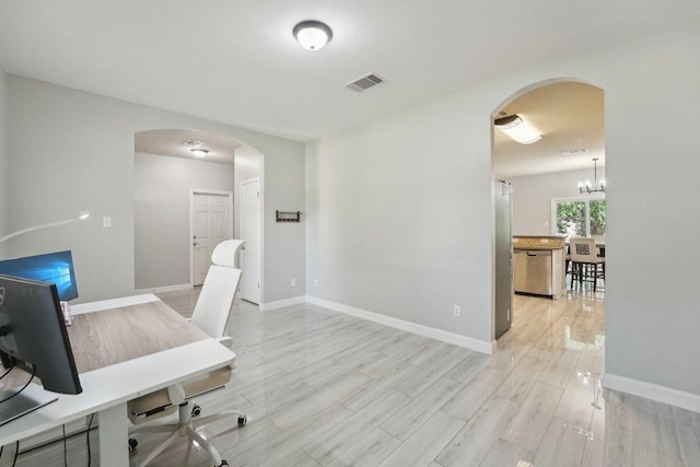 504 Chaparral Dr, Leander, TX 78641 - office space with arched walkways, light wood-style floors, a chandelier, and baseboards
