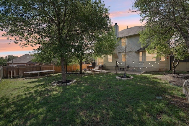 504 Chaparral Dr, Leander, TX 78641 - yard at dusk with a patio