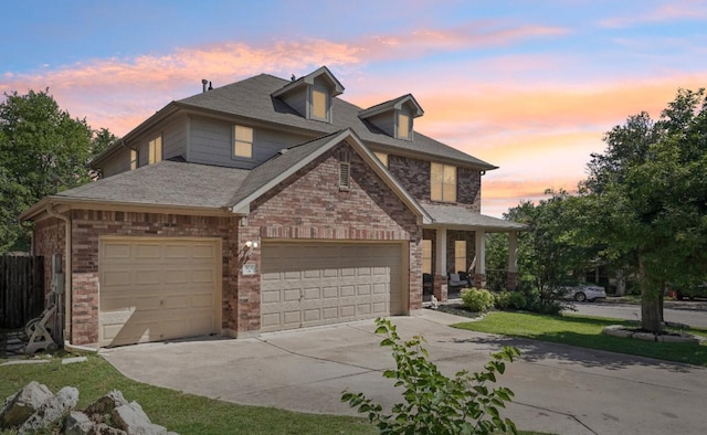 504 Chaparral Dr, Leander, TX 78641 - view of front facade featuring concrete driveway, an attached garage, brick siding, and a shingled roof