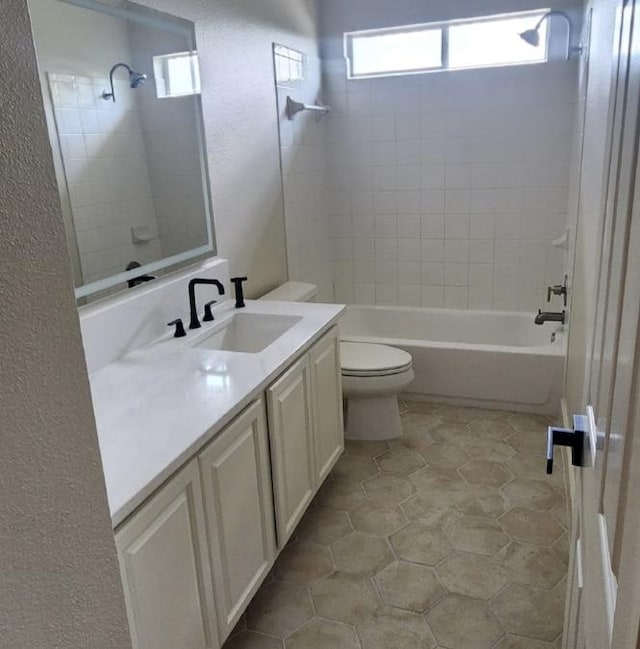 117 Waterloo Dr, Kyle, TX 78640 - bathroom featuring vanity, washtub / shower combination, a textured wall, healthy amount of natural light, and tile patterned floors