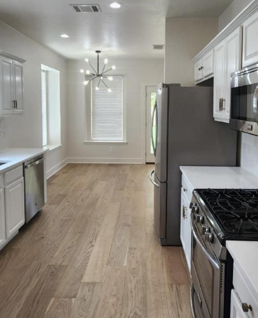 117 Waterloo Dr, Kyle, TX 78640 - kitchen with appliances with stainless steel finishes, a chandelier, and light countertops