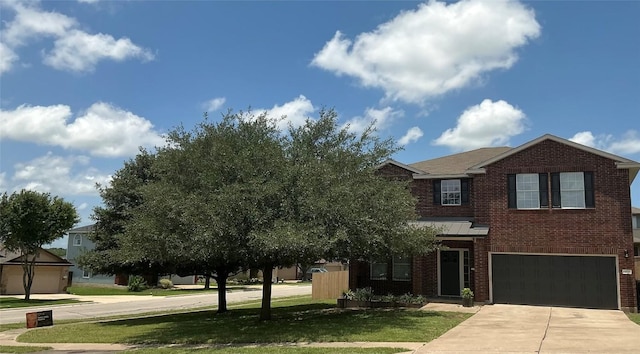 117 Waterloo Dr, Kyle, TX 78640 - view of front of home with brick siding, driveway, an attached garage, and a front yard