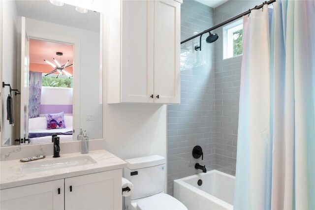 full bath with vanity, shower / bath combo, toilet, and ensuite bathroom