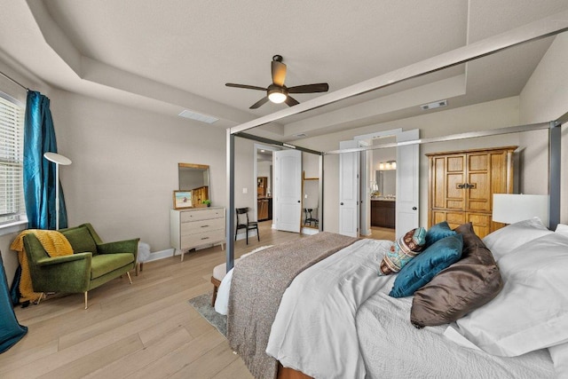 3328 Balboa Way, Round Rock, TX 78665 - bedroom with light wood-style floors, a ceiling fan, and ensuite bath