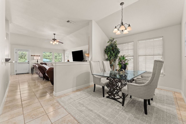 202 Dunkeld Dr, Spicewood, TX 78669 - dining space featuring vaulted ceiling, light tile patterned floors, a chandelier, baseboards, and ceiling fan