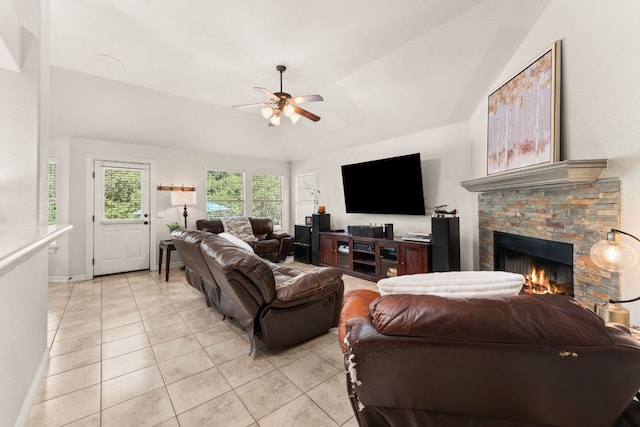 202 Dunkeld Dr, Spicewood, TX 78669 - living room with a ceiling fan, light tile patterned floors, vaulted ceiling, a fireplace, and baseboards