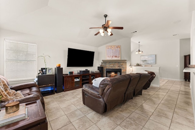 202 Dunkeld Dr, Spicewood, TX 78669 - living area featuring light tile patterned flooring, lofted ceiling, ceiling fan, a stone fireplace, and baseboards