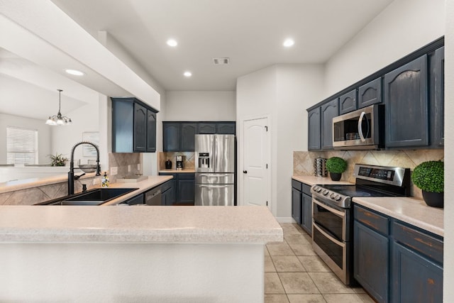 202 Dunkeld Dr, Spicewood, TX 78669 - kitchen featuring stainless steel appliances, a sink, backsplash, a peninsula, and recessed lighting