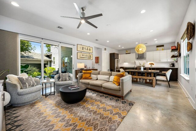 2100 E 10th St, Austin, TX 78702 - living area featuring plenty of natural light, recessed lighting, a ceiling fan, and finished concrete flooring