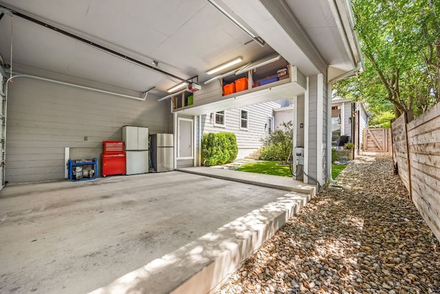 2100 E 10th St, Austin, TX 78702 - garage with freestanding refrigerator and a garage door opener