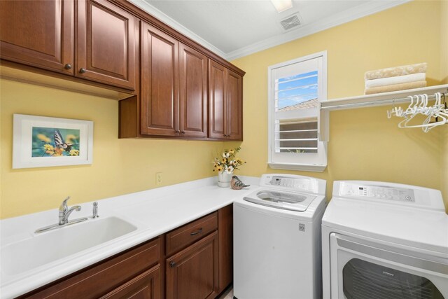 218 Duck Creek Ln, Georgetown, TX 78633 - laundry room featuring cabinet space, washing machine and clothes dryer, and ornamental molding