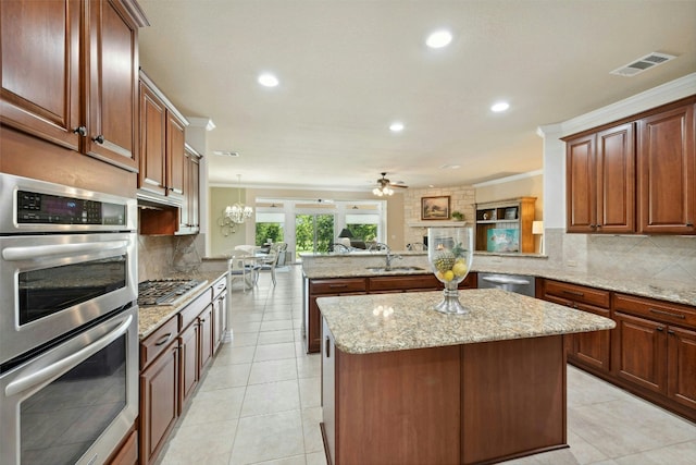 218 Duck Creek Ln, Georgetown, TX 78633 - kitchen featuring stainless steel appliances, a peninsula, a kitchen island, recessed lighting, and tasteful backsplash