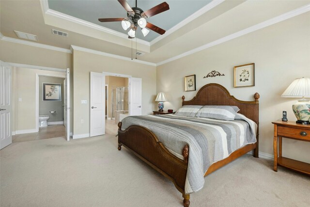 218 Duck Creek Ln, Georgetown, TX 78633 - bedroom with a tray ceiling, light colored carpet, connected bathroom, crown molding, and baseboards