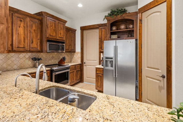 2804 Lohmans Ford Rd Unit B, Lago Vista, TX 78645 - kitchen with appliances with stainless steel finishes, backsplash, light stone countertops, open shelves, and recessed lighting
