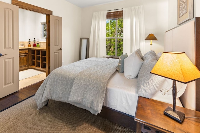 2804 Lohmans Ford Rd Unit B, Lago Vista, TX 78645 - bedroom featuring dark wood finished floors and ensuite bath