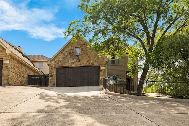 2804 Lohmans Ford Rd Unit B, Lago Vista, TX 78645 - view of front of house featuring driveway, stone siding, and an attached garage