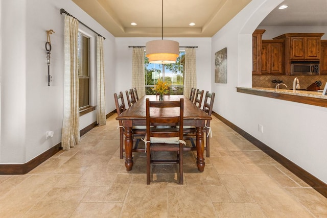 2804 Lohmans Ford Rd Unit B, Lago Vista, TX 78645 - dining area with arched walkways, recessed lighting, a raised ceiling, and light stone finish floors