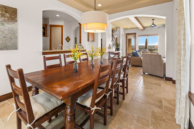 2804 Lohmans Ford Rd Unit B, Lago Vista, TX 78645 - dining room with stone tile floors, a ceiling fan, arched walkways, recessed lighting, and beamed ceiling